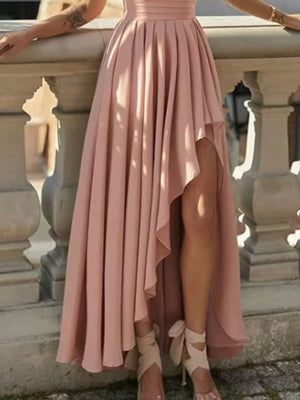 Dusty pink asymmetrical one-shoulder dress with cinched waist and high-low hem.