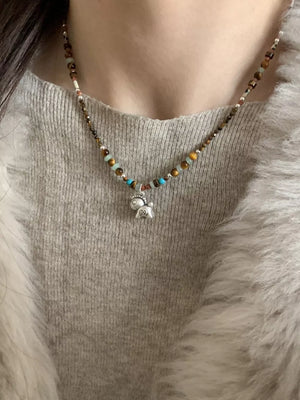silver necklace featuring beaded and beaded
