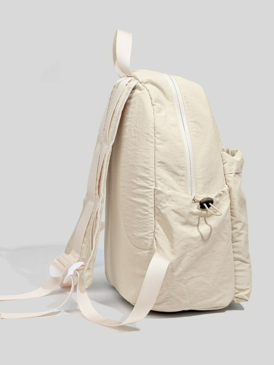 Off-white lightweight nylon backpack with adjustable straps and front drawstring pocket.