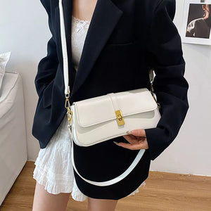 White rectangular crossbody bag with gold clasp and adjustable strap.