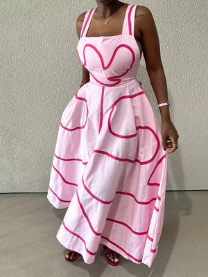 Pink abstract patterned midi dress with square neckline and wide straps.