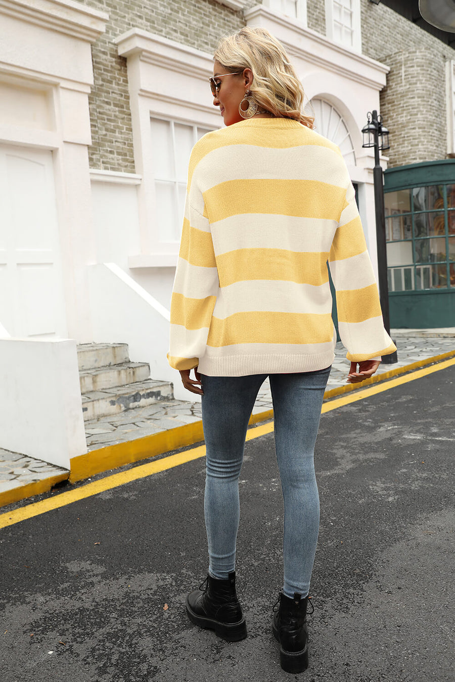 Oversized yellow and cream striped knit sweater with balloon sleeves.