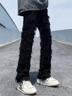 Black distressed slim fit jeans with heavy fraying and ripped details