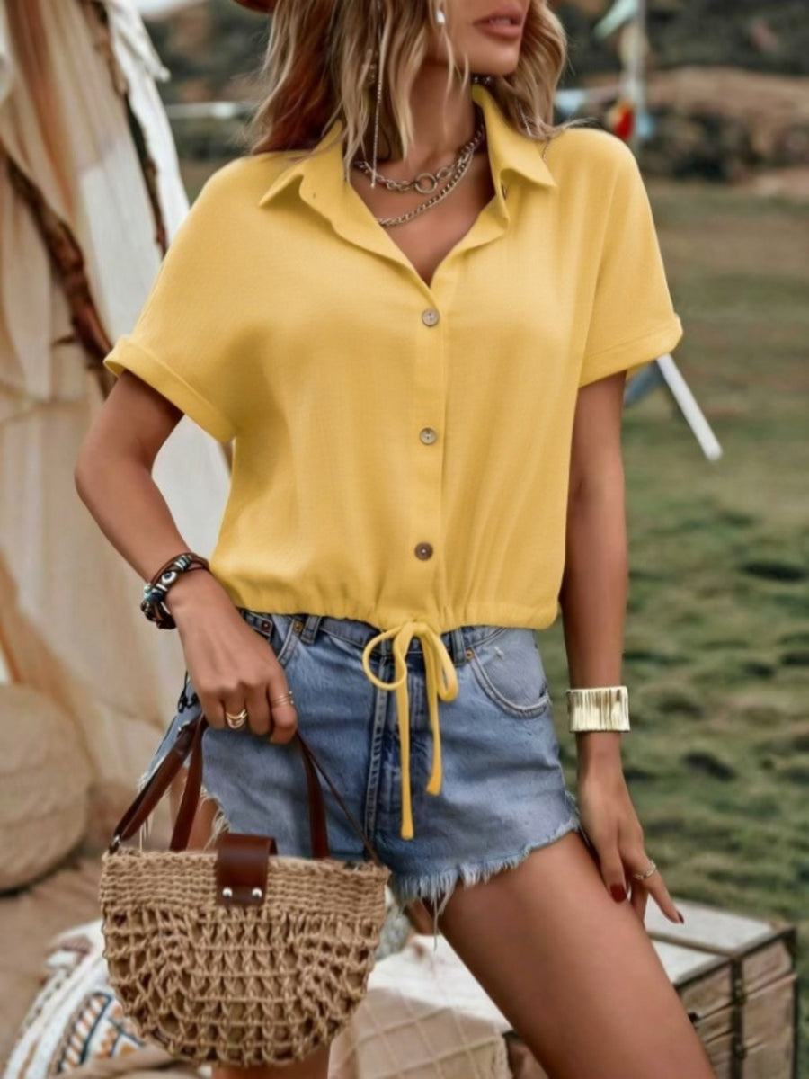 Yellow button-down shirt with drawstring hem, short sleeves, and a collared neckline.