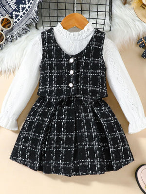 Toddler black and white plaid vest and long sleeve top set with decorative buttons.