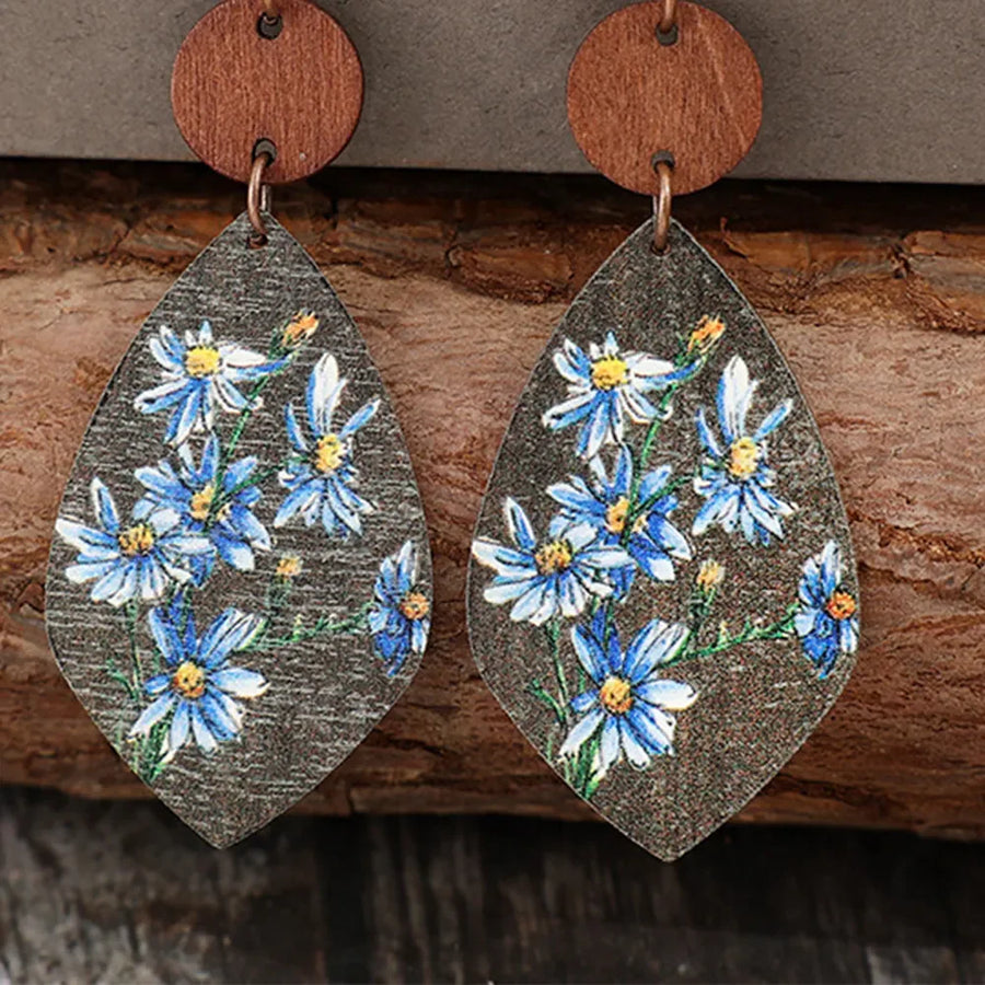 Botanical wood teardrop earrings with blue floral print and wooden top detail.