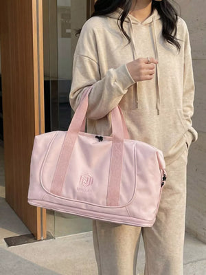 Pink duffel bag with embroidered logo and pink straps