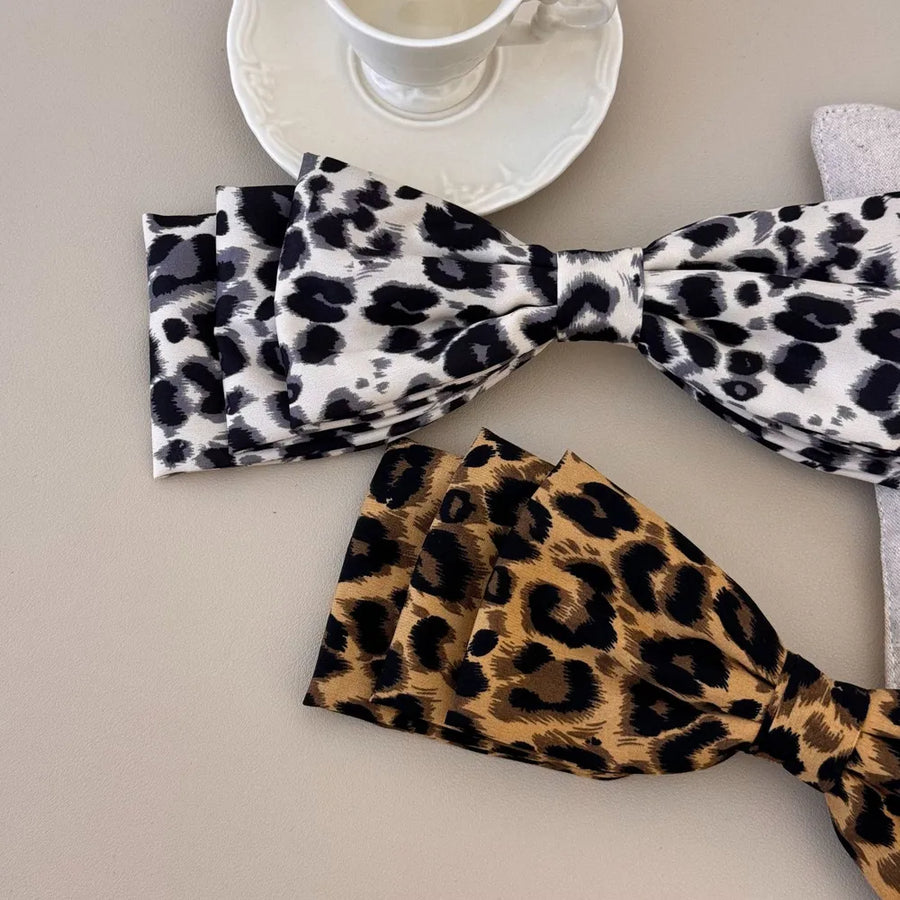 Oversized leopard print hair bows in black and white and brown.