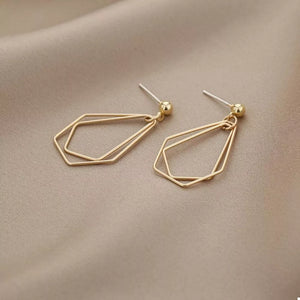 Gold earrings featuring drop earrings and geometric