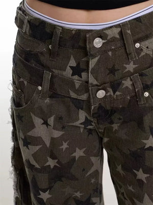 Distressed wide-leg jeans with a dark star print and raw hem detail.