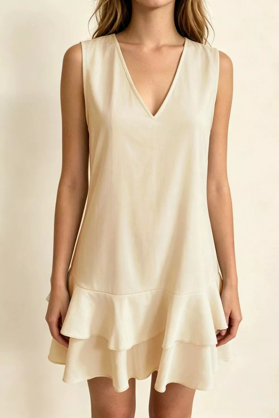 Beige v-neck mini dress with ruffle hem and sleeveless design