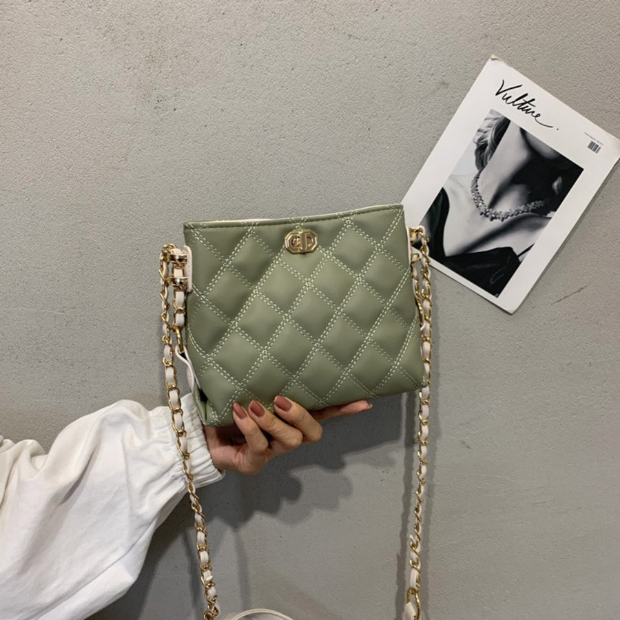 Green quilted crossbody bag with diamond pattern and gold chain strap.