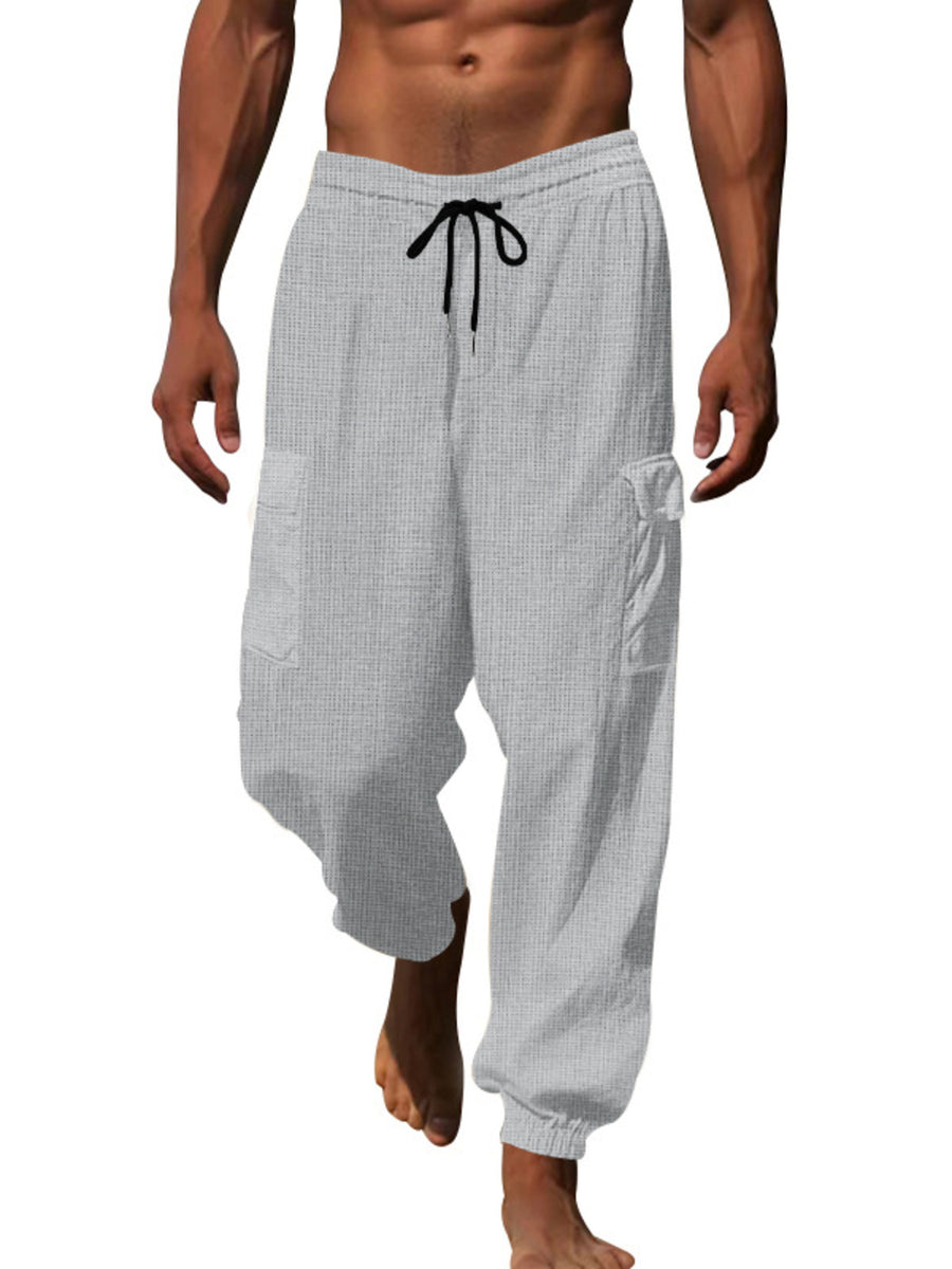 Light gray waffle knit joggers with drawstring and cargo pockets.