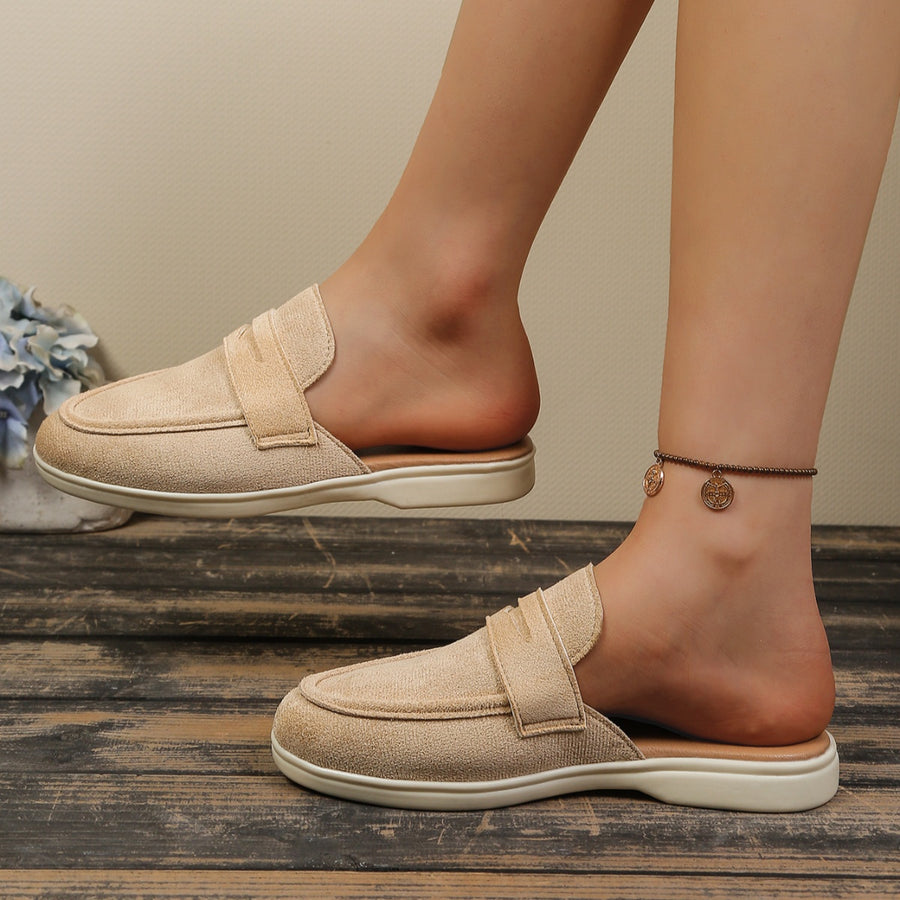 Khaki textured round toe slip-on loafers with backless design and decorative strap detail.
