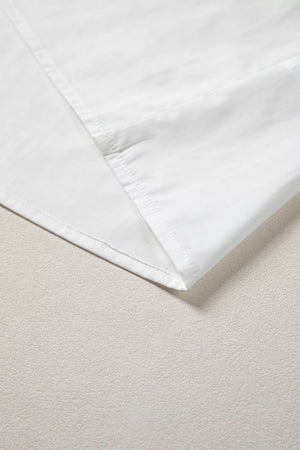 White cotton shirt with pleated detail and stitched hem
