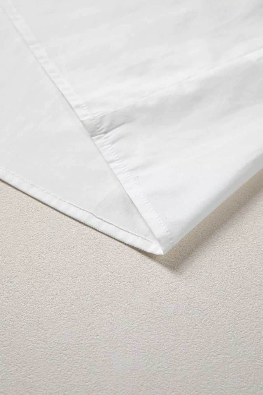 White cotton shirt with pleated detail and stitched hem