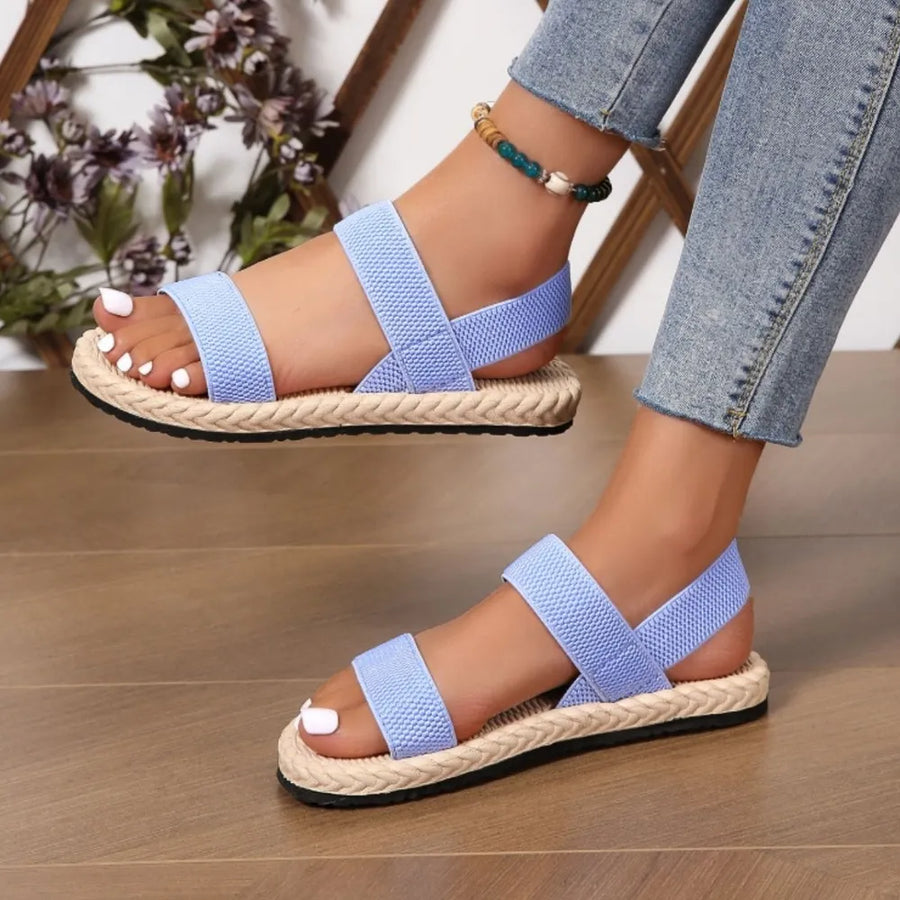Light blue rope-sole cross-strap sandals with elastic straps and espadrille trim.