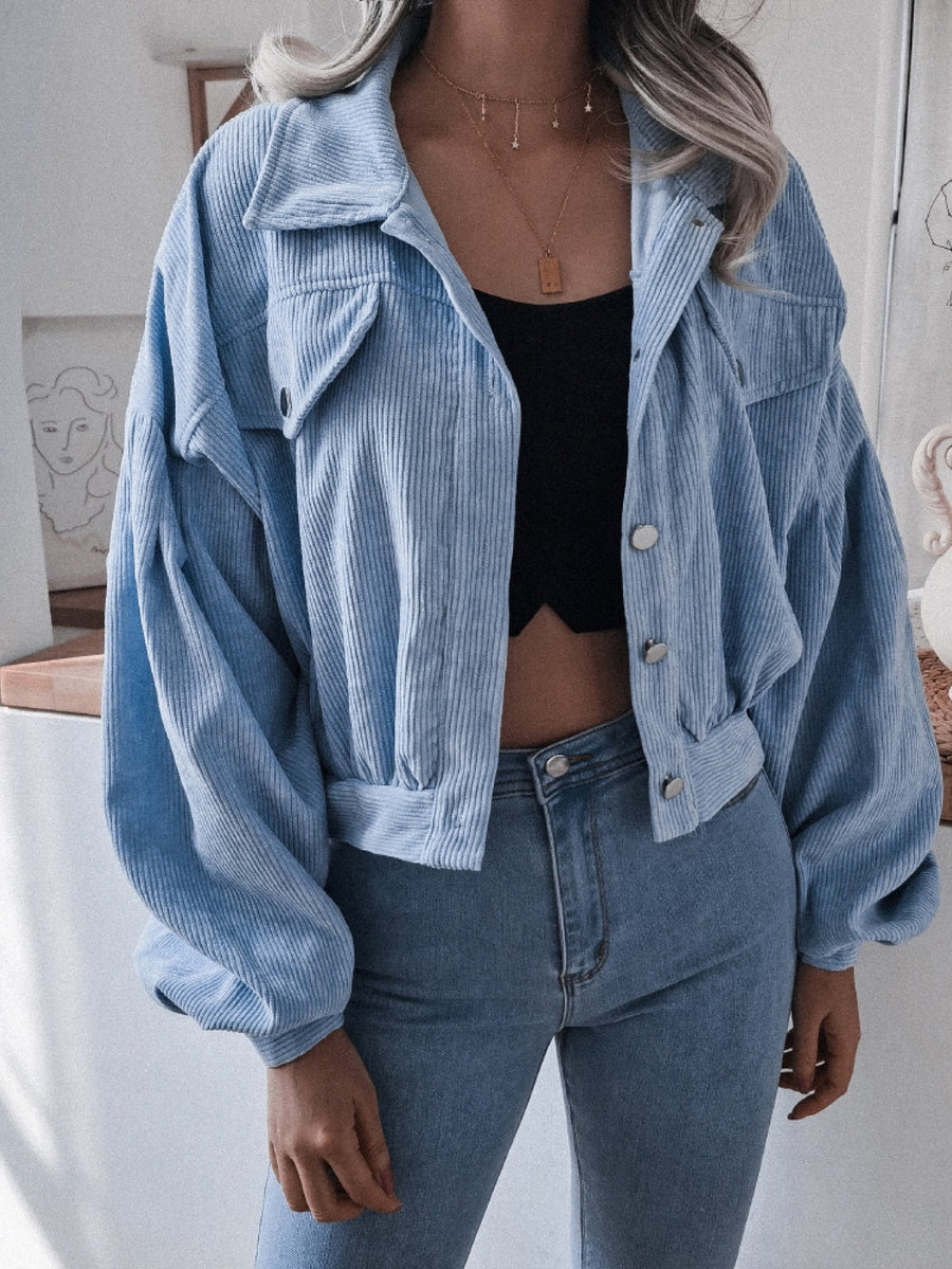 Blue corduroy cropped jacket with balloon sleeves and button-up front.