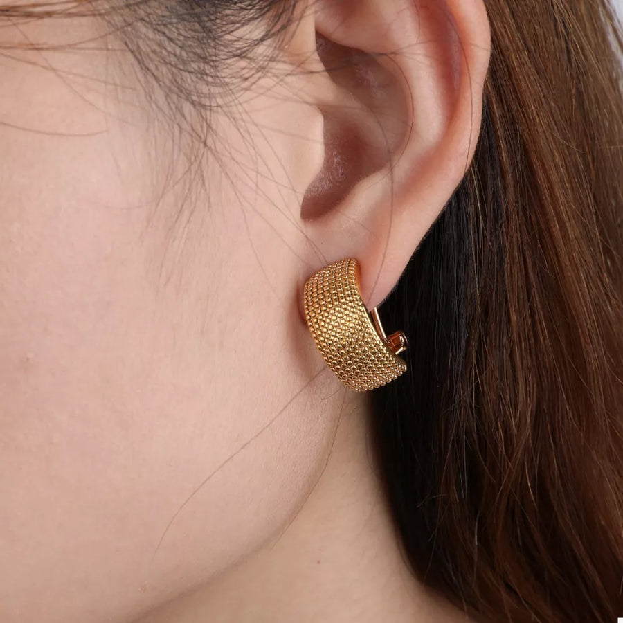 earrings in gold with textured and textured