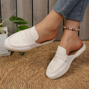 Textured round toe slip-on loafers in a light beige color with a backless design.