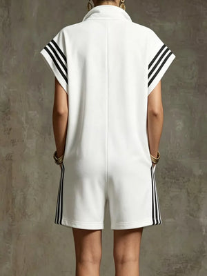 White sporty zip-up romper with black stripes on sleeves and sides, and pockets.