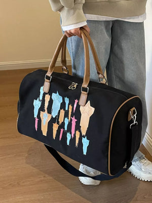 Black canvas duffle bag with multicolor star design and adjustable strap