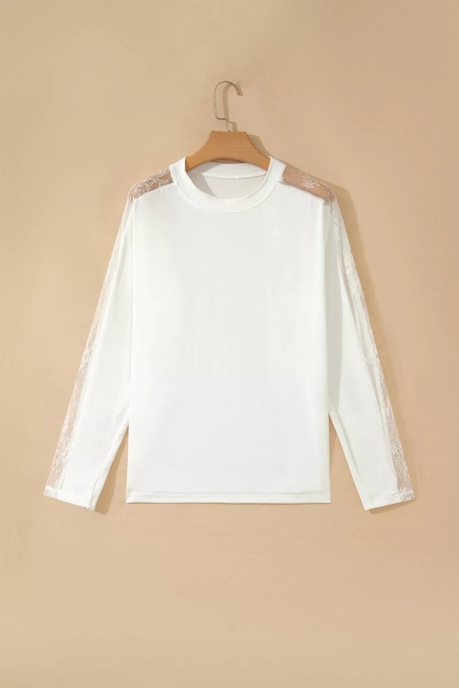 White long sleeve shirt with delicate lace shoulder and sleeve details, crew neckline.