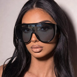 sunglasses in black featuring UV protection and oversized fit