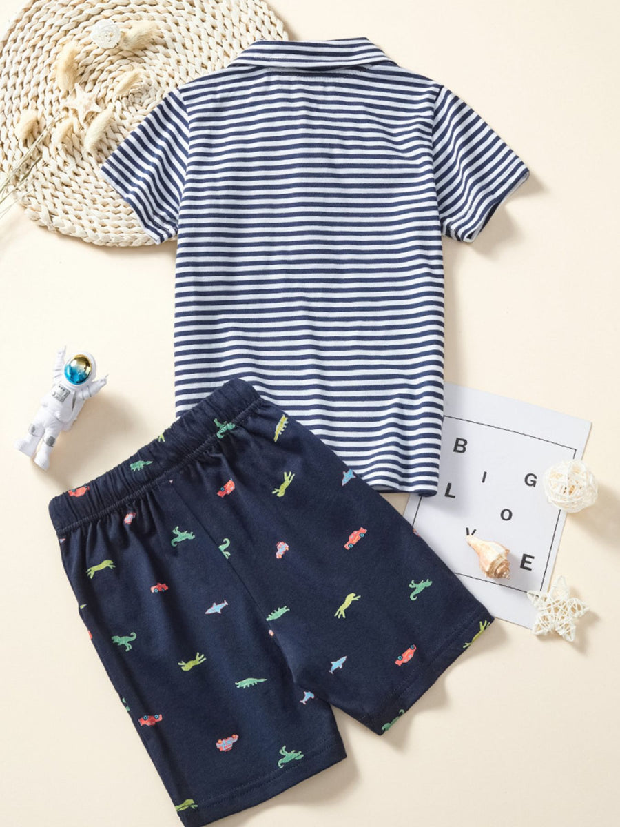 Toddler polo shirt with navy and white stripes and dinosaur print shorts.