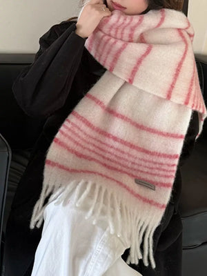 Chic pink and white striped scarf with fringe hem, cozy accessory.
