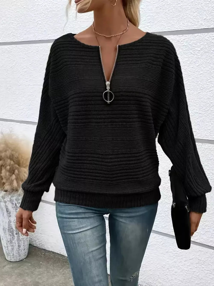 Black ribbed quarter zip sweatshirt with O-ring pull and dolman sleeves.