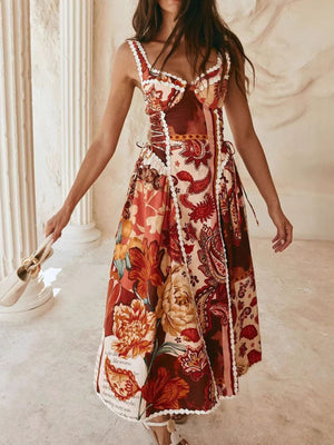 Midi dress with paisley floral print, lace trim, sweetheart neckline, and tie sides.