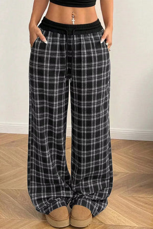 wide-leg pants in black featuring drawstring waist and loose fit