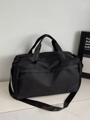 Black nylon duffel bag with top handles and adjustable shoulder strap