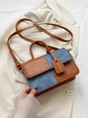 Chic two-tone brown and blue PU leather crossbody handbag with a top handle and tag.