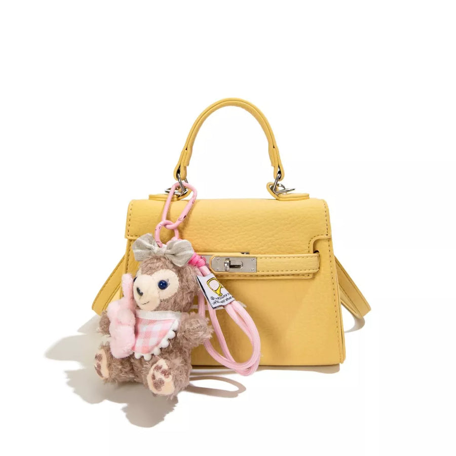pale yellow handbag with detachable strap and null