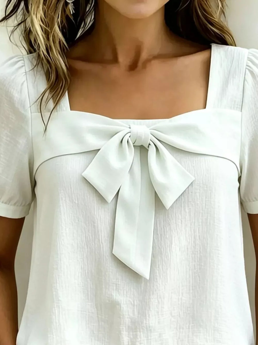 Light Green puff sleeve shirt with a large bow tie detail at the square neckline.