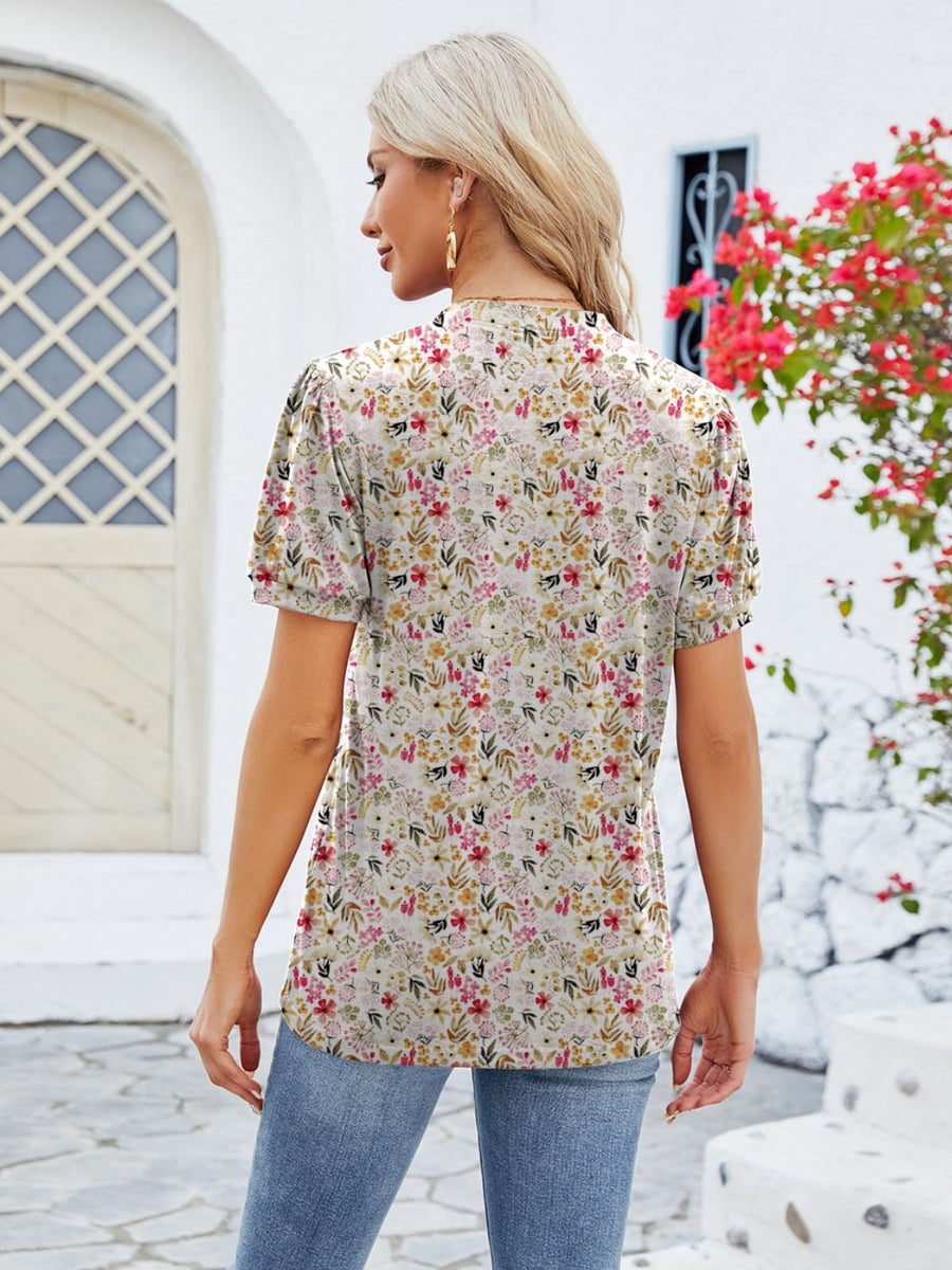 Floral print blouse with short sleeves and a keyhole neckline, shown from the back.