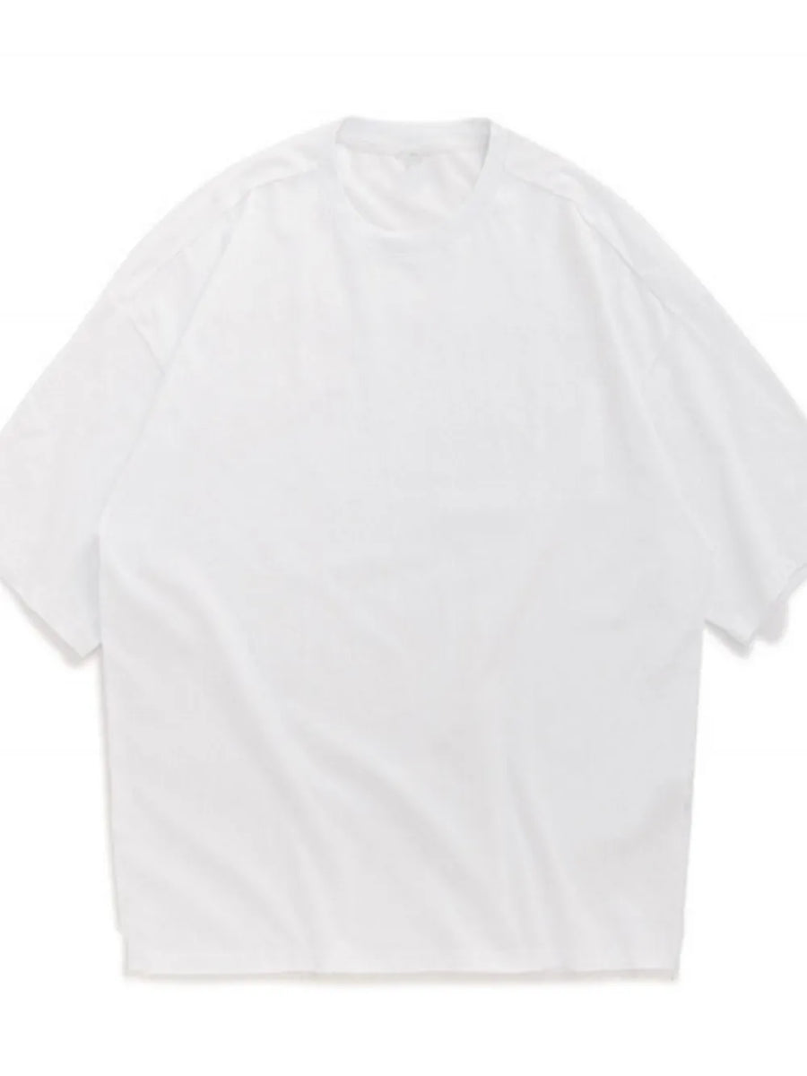Oversized white crew neck t-shirt with textured fabric and short sleeves.