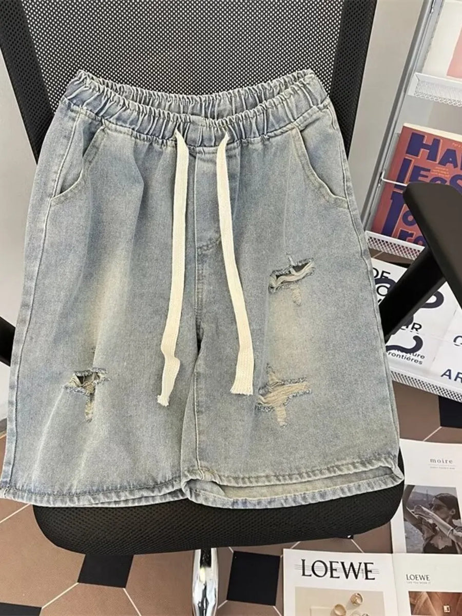 Light blue distressed denim shorts with drawstring and raw hem