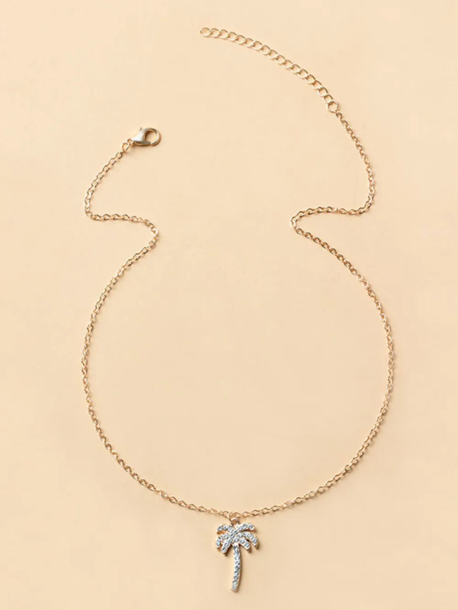 necklace featuring palm tree motif in clear with lace texture