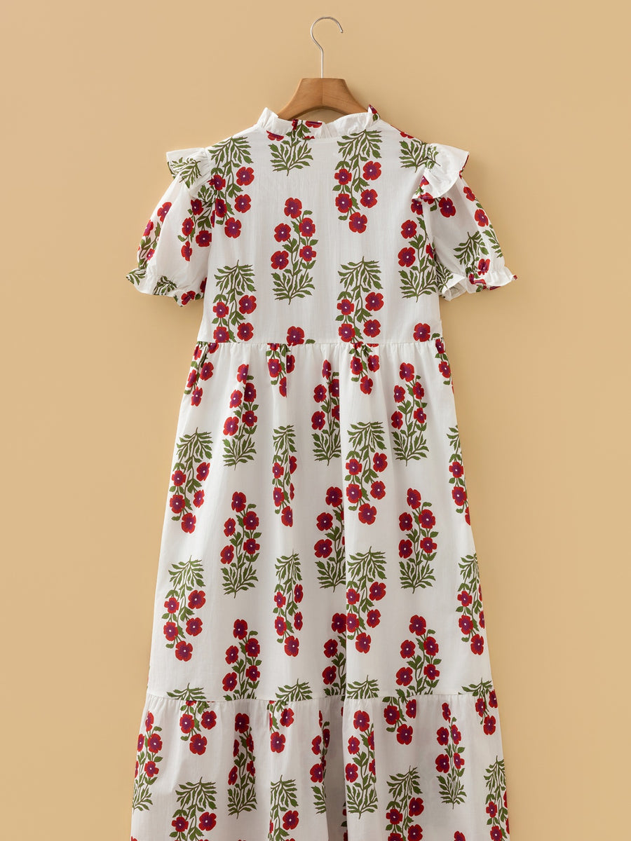White cotton mini dress with red floral print, ruffled neckline and sleeves.