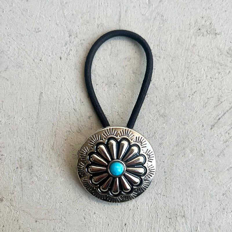 Southwestern medallion hair tie with aqua stone and alloy detail.