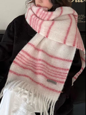 Chic pink and white striped scarf with fringe hem and a small gray tag.