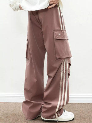 Oversized cargo pants in dusty pink with flap pockets and side stripe detail.