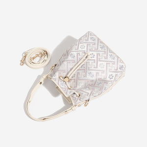 Cream crossbody bag featuring drawstring closure and geometric