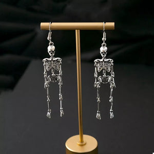 Silver earrings featuring dangle and figural