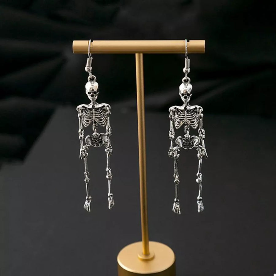 Silver earrings featuring dangle and figural