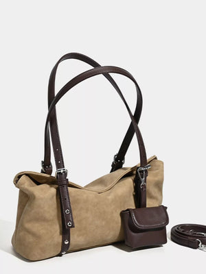 Suede medium shoulder bag in brown with adjustable straps and a small attached pouch.