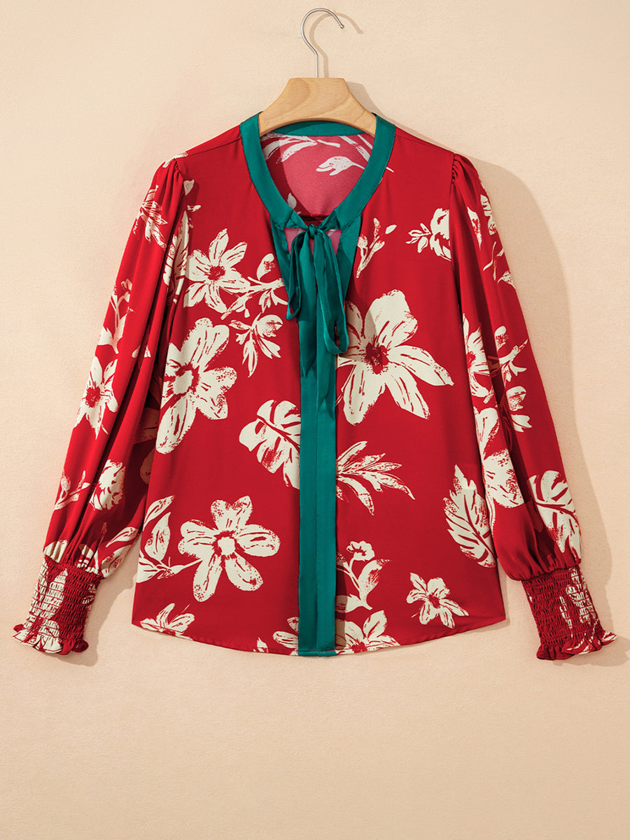 Red floral print blouse with bow tie detail and smocked cuffs